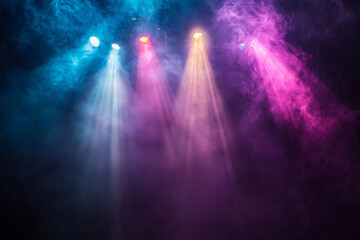 Colorful smoke and lights in a dramatic concert atmosphere with illuminated beams