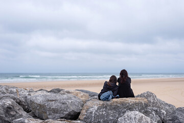 A couple of friends sitting looking out to sea in Les Landes, Aquitaine Coast.