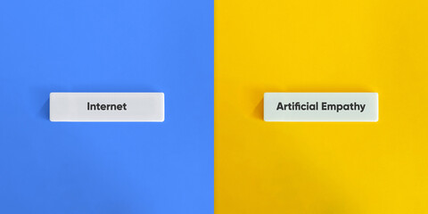 Internet Versus Artificial Empathy Concept on Wide Letter Tiles with Blue and Yellow Background