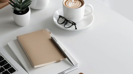 Minimalist Workspace Setup Featuring Coffee, Notebook, Pen, Glasses, and Laptop on a Clean White Surface for Enhanced Productivity