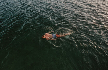 Man surface snorkeling, above waterline, snorkeling vacation in Belize