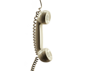 Retro beige telephone handset with coiled cord hanging isolated on white background