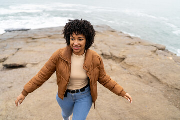 Young woman enjoying a morning walk by the sea