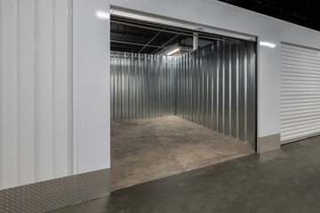 Empty Indoor Self Storage Unit with Metal Walls and Concrete Floor