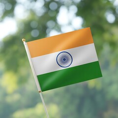 An indian flag waving in the wind against a blurred natural background