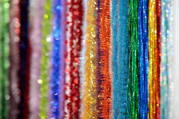 colorful glitter tinsel garlands in Christmas fair