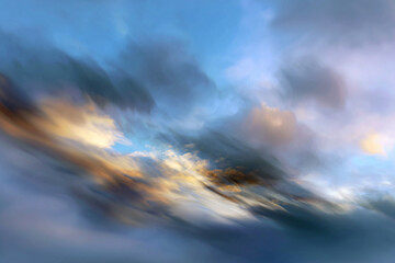 Abstract motion blur of colorful clouds at sunset creating a dynamic and dreamy sky scene