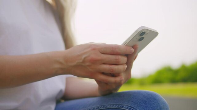 Woman chatting online on smartphone macro close up, typing text message, touching touchscreen keyboard, using messenger application. Female holding mobile phone, close up, swiping social media. 