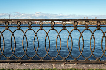 Decorative cast iron fence installed on the embankment in the city of Vyborg.