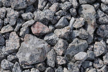 Pile of grey stone pebbles as background texture close up