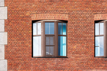 Rectangular window with brown frame against red brick wall. From the Windows of the World series.