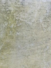 Mossy cement wall with weather stains and green hues, ideal for grunge or natural texture...