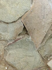 Layered natural stone texture with stacked rock arrangement, perfect for construction background, wall design, and rustic materials