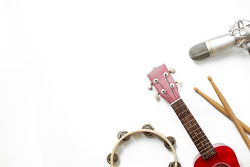Musical instruments for band - small guitar, drumsticks and tambourine with studio microphone....