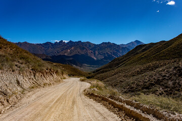 Scenic dirt road in the remote valleys of Salta, Argentina. Arid mountains and vast skies...