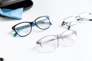 Stylish eyeglasses with glasses case on white. Eye care and protection concept
