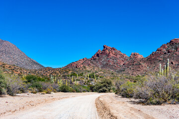 Scenic dirt road in the remote valleys of Salta, Argentina. Arid mountains and vast skies characterize this stunning Andean landscape. Off-road travel destination