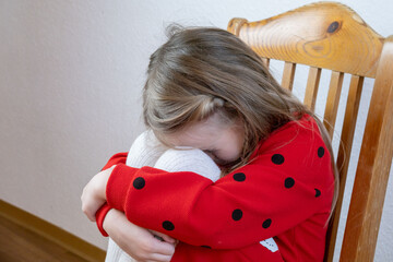little child 5 years old in tears, blonde girl cries, covering face, early diagnosis and...