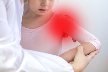 Female doctor, nurse examining injured little ballerina's arm, training accident, child pain,...