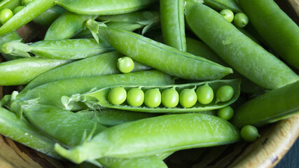green young peas in pods in a bowl