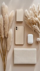Beige Wireless Devices and Pampas Grass Flatlay.
