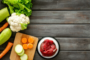 Natural pet food and ingredients - meat and vegetables zucchini, carrots and greens, cauliflower