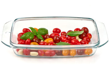 Cherry Tomatoes with Garlic, Basil in Glass Dish, isolated on white background