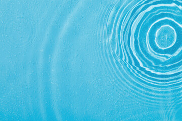 drops on water with circles on a blue background