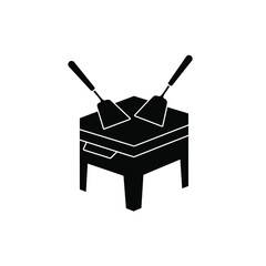 Fototapeta premium Black silhouette of two spatulas on a grill cooking