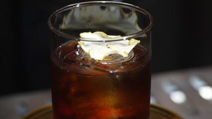 Closeup in opening mist of rotated mixed smokey Old fashion cocktail glass decorated dried sliced...