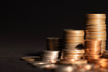 Stack of golden coins isolated on black background