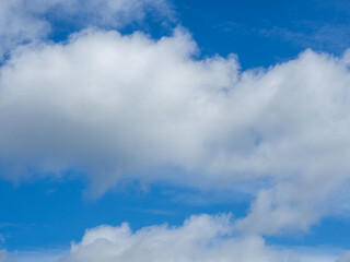 White, fluffy clouds in blue sky. Background from clouds. Weather forecast for tomorrow
