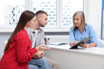 In vitro fertilization (IVF). Couple having consultation with doctor in reproductive clinic