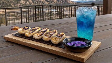 Freshly grilled prawns and colorful drink served on bamboo tray scenic outdoor dining relaxed atmosphere