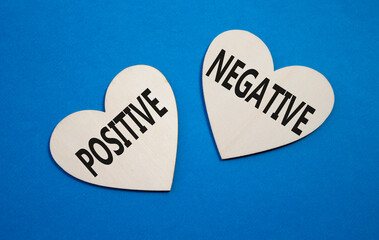 Positive or Negative symbol. Concept word Positive or Negative on wooden hearts. Beautiful blue...