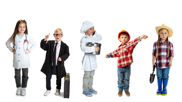 Group of kids dressed in professional uniforms like doctor, lawyer, chef, builder and farmer standing in row. Concept of career exploration, childhood imagination, early education, professional