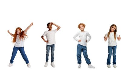 Group of diverse children in casual white shirts and jeans posing together expressing joy...