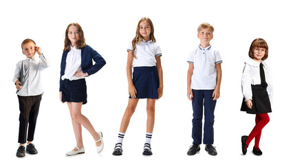 Group of schoolchildren in uniform standing isolated on white background. Concept of education,...