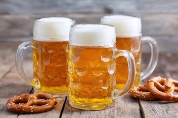 Three frosty beer mugs filled with golden lager, surrounded by soft pretzels on a rustic wooden table, capturing the festive spirit of celebration and camaraderie