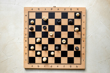 Top view of chess pieces and chessboard during the game