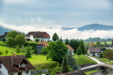 Morning fog over village in Slovenian countryside
