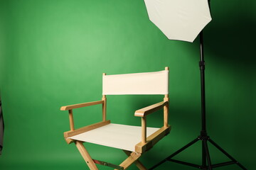 Chair of Film Director. Directors chair in green screen studio setup with softbox lighting. Ideal...