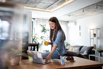Freelancer working from home enjoying breakfast and orange juice