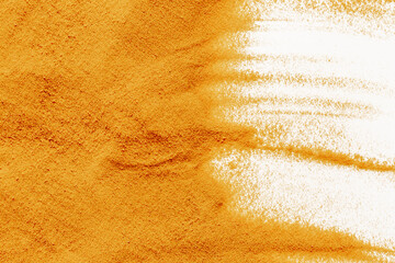 Frame of yellow sand texture on white background, close up top view. Abstract sand surface
