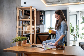 Freelancer working from home enjoying breakfast and orange juice