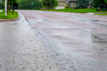 Backed up standing water on a residential street after a rain storm downpour. 