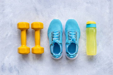 Flat lay of fitness sports equipment. Sneakers and dumbbells for gym. Wellness concept