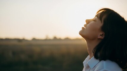 Woman Embraces Golden Sunset in Serene Field - Powered by Adobe