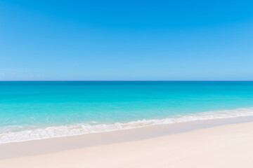 Obraz premium Beautiful Tropical Beach Scene with Gentle Turquoise Waves, Soft White Sand and Clear Sunny Sky 