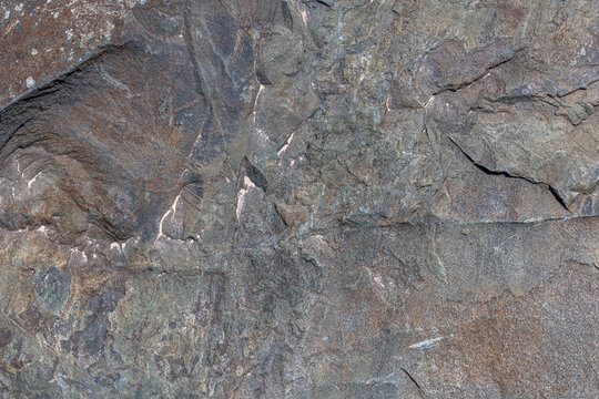 Rough solid sedimentary rock face texture and background